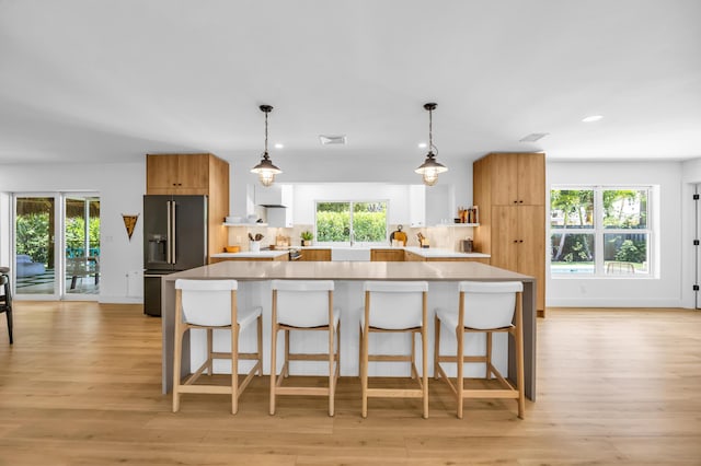 354 Country Club Dr, Tequesta, FL 33469 - kitchen with high quality fridge, healthy amount of natural light, light countertops, and recessed lighting