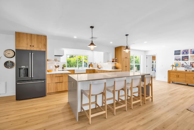 354 Country Club Dr, Tequesta, FL 33469 - kitchen with high quality fridge, open shelves, recessed lighting, and light wood-style flooring