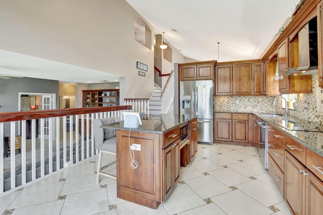 1503 NW 159th Ln, Pembroke Pines, FL 33028 - kitchen with stainless steel appliances, a sink, brown cabinetry, dark stone countertops, and decorative backsplash