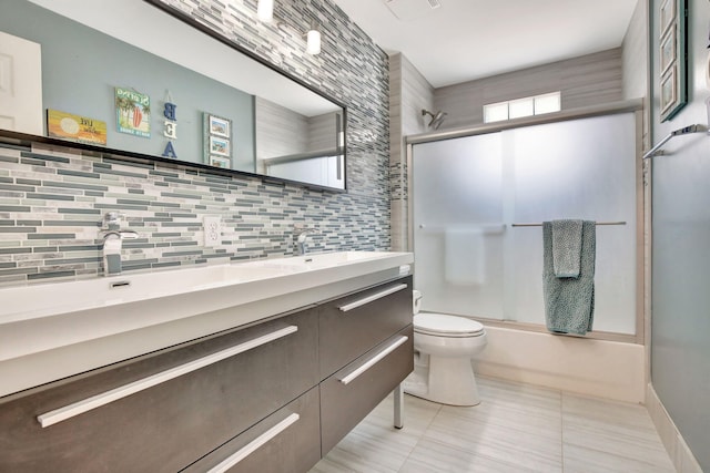 1503 NW 159th Ln, Pembroke Pines, FL 33028 - full bathroom featuring decorative backsplash, toilet, double vanity, tile patterned flooring, and shower / bath combination with glass door