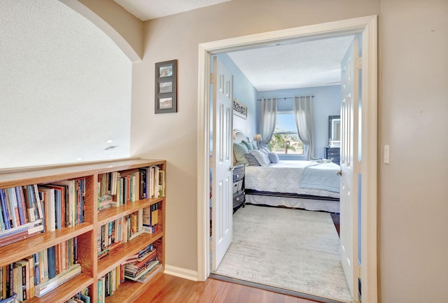 1503 NW 159th Ln, Pembroke Pines, FL 33028 - bedroom with wood finished floors, arched walkways, a textured ceiling, and baseboards