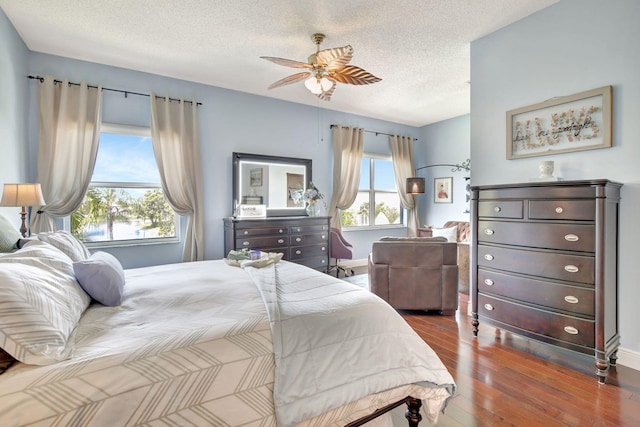 1503 NW 159th Ln, Pembroke Pines, FL 33028 - bedroom with a textured ceiling, wood finished floors, a ceiling fan, and baseboards