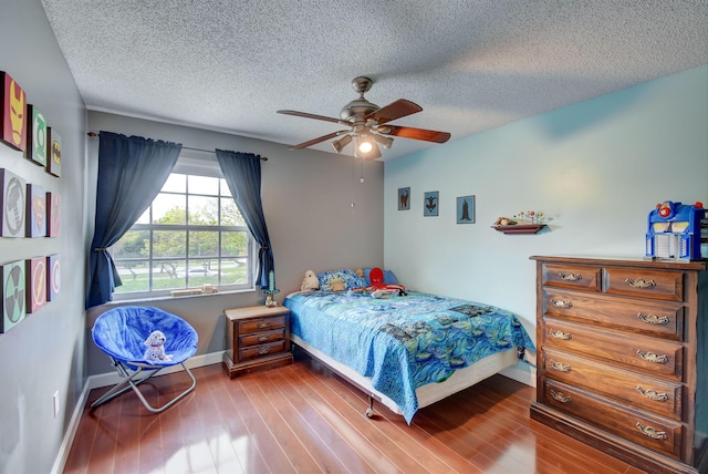 1503 NW 159th Ln, Pembroke Pines, FL 33028 - bedroom featuring baseboards, wood finished floors, a textured ceiling, and a ceiling fan
