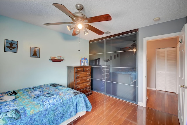 1503 NW 159th Ln, Pembroke Pines, FL 33028 - bedroom featuring wood finished floors, a textured ceiling, and a ceiling fan