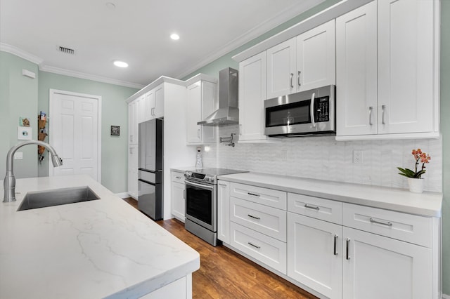 49 Lancaster Rd, Boynton Beach, FL 33426 - kitchen with stainless steel appliances, wall chimney range hood, ornamental molding, white cabinetry, and tasteful backsplash