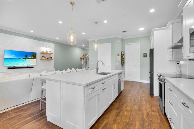 49 Lancaster Rd, Boynton Beach, FL 33426 - kitchen featuring appliances with stainless steel finishes, a breakfast bar, ornamental molding, recessed lighting, and white cabinetry