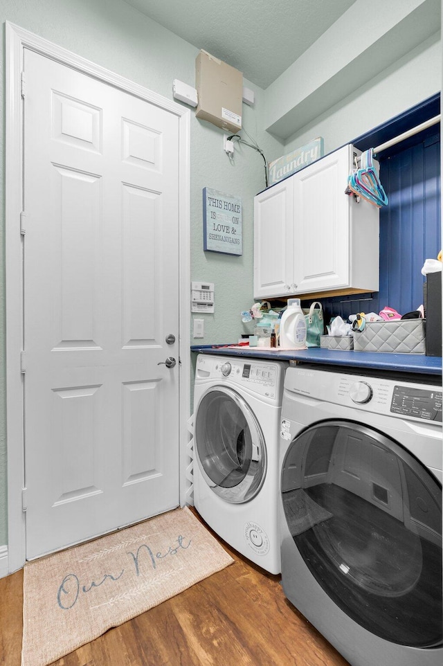 49 Lancaster Rd, Boynton Beach, FL 33426 - laundry room with washing machine and clothes dryer, cabinet space, and wood finished floors