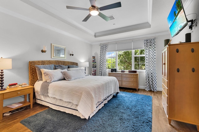 49 Lancaster Rd, Boynton Beach, FL 33426 - bedroom featuring a raised ceiling, crown molding, wood finished floors, and ceiling fan