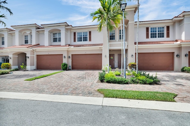 49 Lancaster Rd, Boynton Beach, FL 33426 - townhome / multi-family property with an attached garage, stucco siding, a tile roof, and driveway