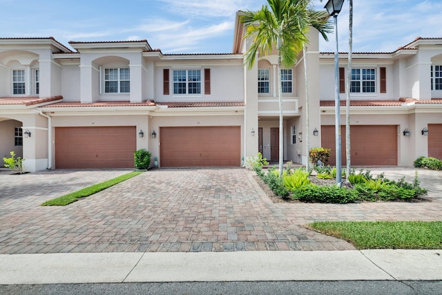 49 Lancaster Rd, Boynton Beach, FL 33426 - multi unit property featuring an attached garage, stucco siding, a tiled roof, and driveway