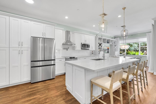 49 Lancaster Rd, Boynton Beach, FL 33426 - kitchen featuring stainless steel appliances, wall chimney exhaust hood, crown molding, white cabinets, and wood finished floors