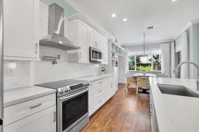 49 Lancaster Rd, Boynton Beach, FL 33426 - kitchen featuring wall chimney exhaust hood, stainless steel appliances, recessed lighting, ornamental molding, and dark wood-type flooring