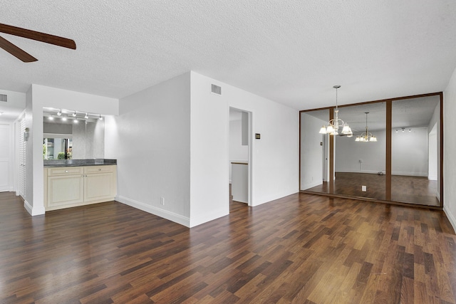 6612 Spring Bottom Way Unit 186, Boca Raton, FL 33433 - unfurnished living room with a ceiling fan, dark wood-style flooring, a chandelier, track lighting, and a textured ceiling
