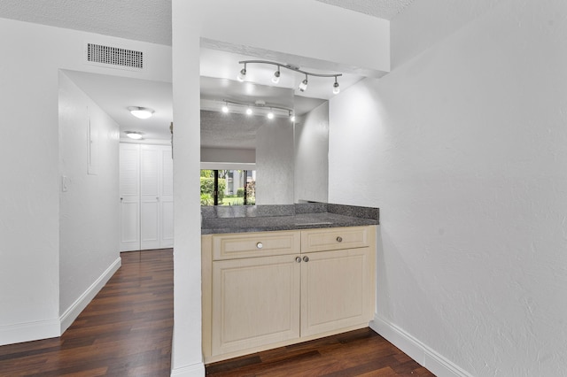 6612 Spring Bottom Way Unit 186, Boca Raton, FL 33433 - bar with dark wood-type flooring, baseboards, a textured ceiling, and rail lighting