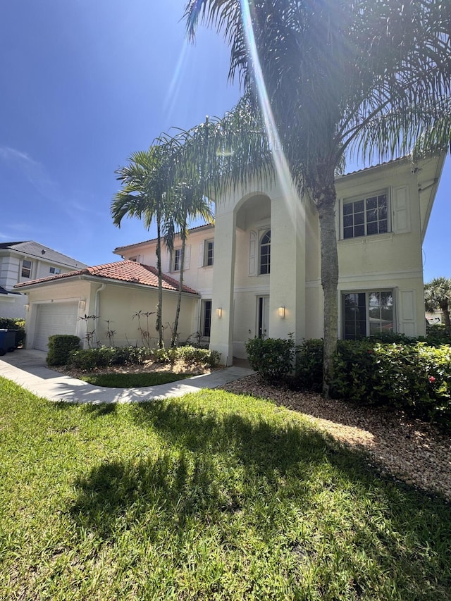 220 Blackbird Ln, Jupiter, FL 33458 - view of front facade with stucco siding, a garage, a front lawn, and a tile roof