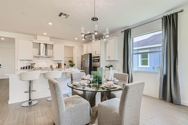 6783 Cobia Cir, Boynton Beach, FL 33437 - dining room with light wood-style flooring, recessed lighting, and a chandelier