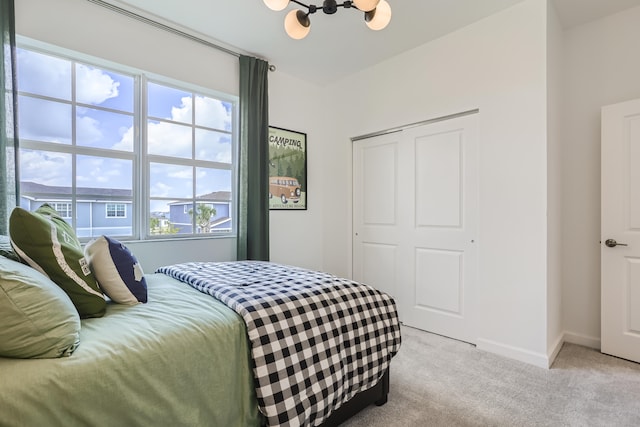 6783 Cobia Cir, Boynton Beach, FL 33437 - bedroom featuring a chandelier, light carpet, multiple windows, and a closet