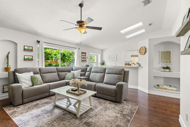 1262 SW Hunnicut Ave, Port Saint Lucie, FL 34953 - living room featuring wood finished floors, ceiling fan, built in shelves, lofted ceiling, and a textured ceiling