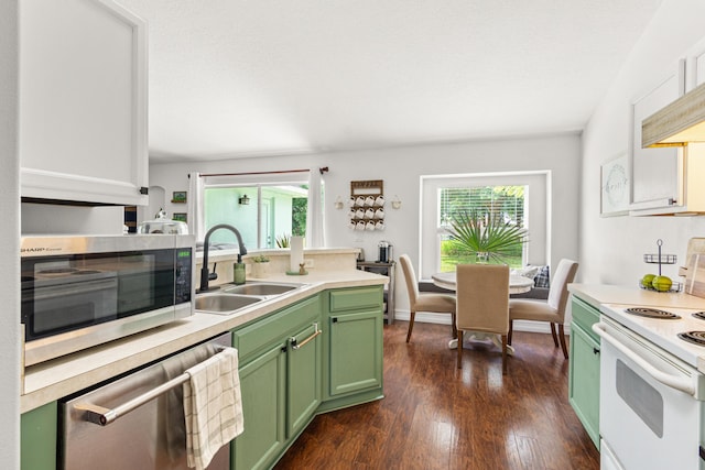 1262 SW Hunnicut Ave, Port Saint Lucie, FL 34953 - kitchen featuring green cabinetry, stainless steel appliances, a sink, dark wood-style floors, and light countertops