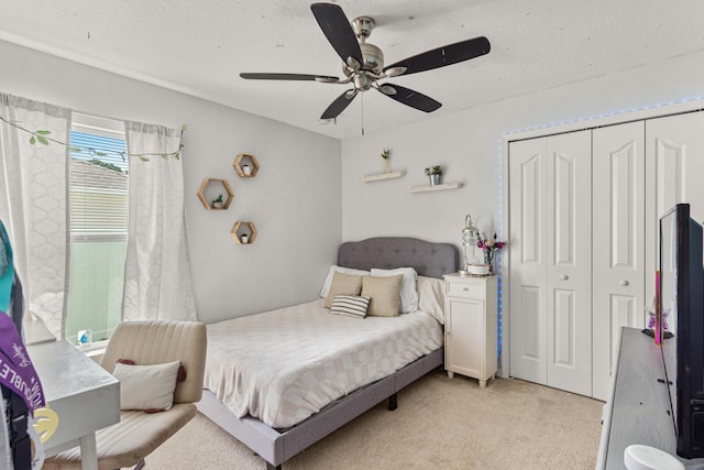 1262 SW Hunnicut Ave, Port Saint Lucie, FL 34953 - bedroom with a closet, light carpet, a ceiling fan, and a textured ceiling
