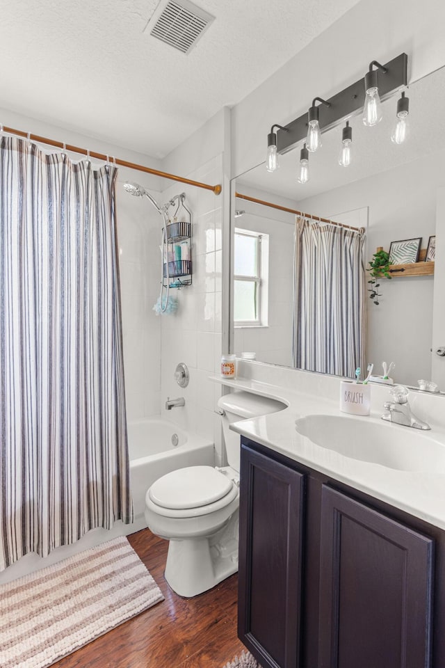 1262 SW Hunnicut Ave, Port Saint Lucie, FL 34953 - bathroom with wood finished floors, shower / tub combo, vanity, toilet, and a textured ceiling
