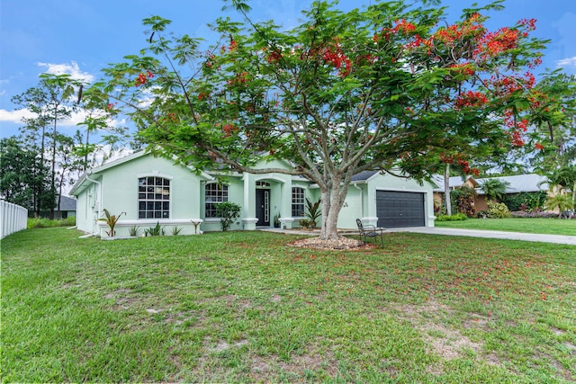 1262 SW Hunnicut Ave, Port Saint Lucie, FL 34953 - view of front of home with driveway, stucco siding, a front lawn, and an attached garage