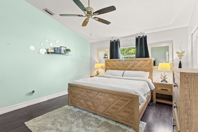 1262 SW Hunnicut Ave, Port Saint Lucie, FL 34953 - bedroom with dark wood finished floors, vaulted ceiling, baseboards, a textured ceiling, and ceiling fan