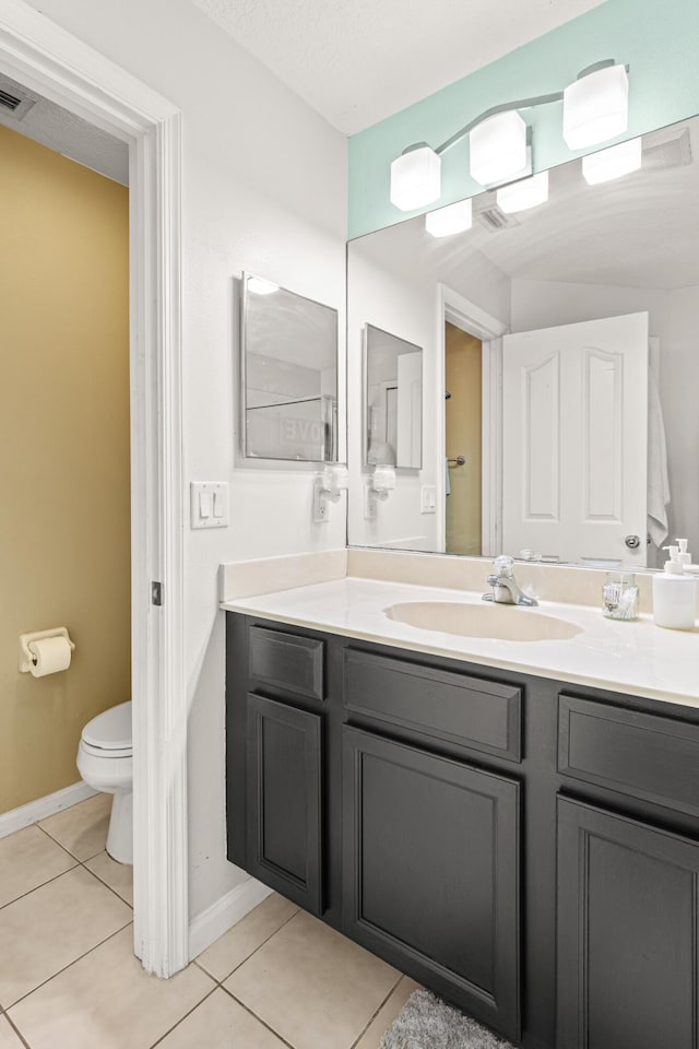 1262 SW Hunnicut Ave, Port Saint Lucie, FL 34953 - bathroom with vanity, tile patterned flooring, toilet, and baseboards