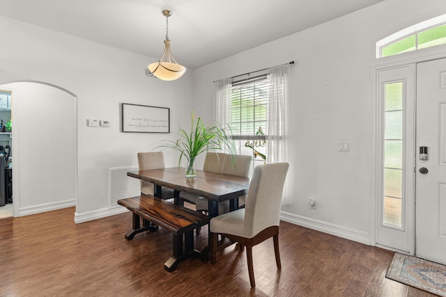 1262 SW Hunnicut Ave, Port Saint Lucie, FL 34953 - dining area with wood finished floors, baseboards, and arched walkways