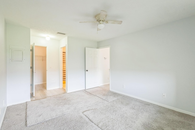 6537 SE Federal Hwy Unit 202, Stuart, FL 34997 - unfurnished bedroom with carpet, baseboards, a walk in closet, and a ceiling fan
