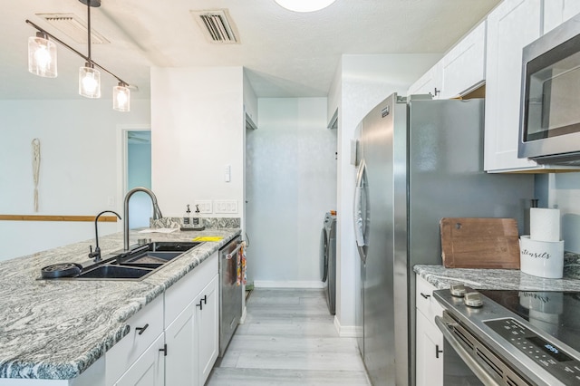 6537 SE Federal Hwy Unit 202, Stuart, FL 34997 - kitchen with appliances with stainless steel finishes, a sink, light wood-style flooring, and white cabinetry