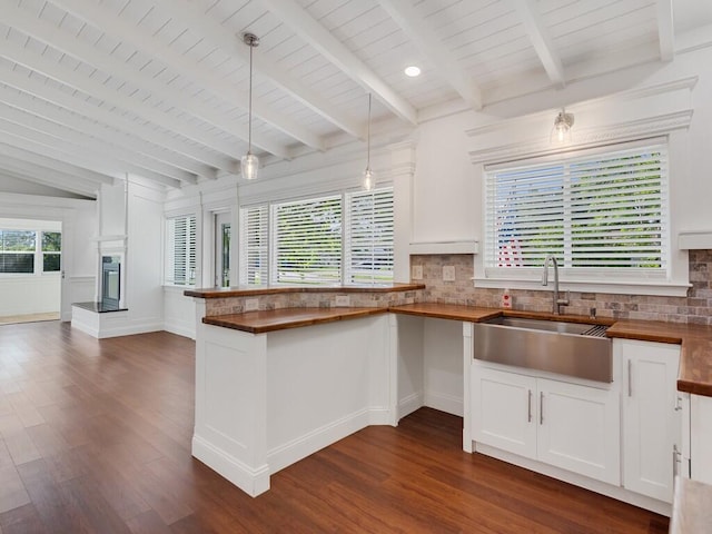 3416 Atlantic Blvd, Vero Beach, FL 32960 - kitchen featuring butcher block counters, a sink, backsplash, a peninsula, and dark wood finished floors