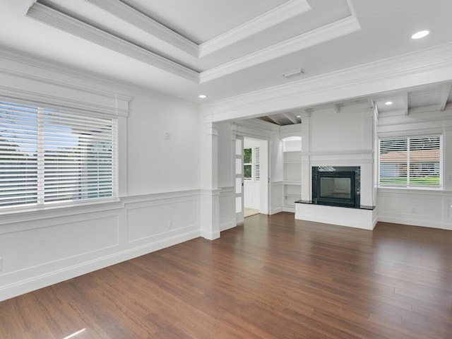 3416 Atlantic Blvd, Vero Beach, FL 32960 - unfurnished living room with healthy amount of natural light, a decorative wall, dark wood-type flooring, ornamental molding, and a tray ceiling