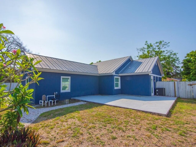 3416 Atlantic Blvd, Vero Beach, FL 32960 - back of property with metal roof, a patio, and cooling unit