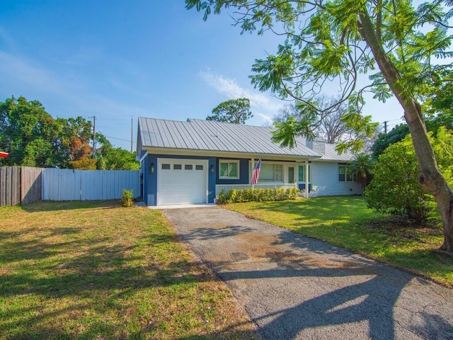 3416 Atlantic Blvd, Vero Beach, FL 32960 - view of front of house with asphalt driveway, an attached garage, and metal roof