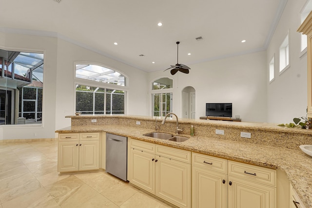 5036 NW 24th Cir, Boca Raton, FL 33431 - kitchen with cream cabinetry, dishwasher, a sink, arched walkways, and a ceiling fan