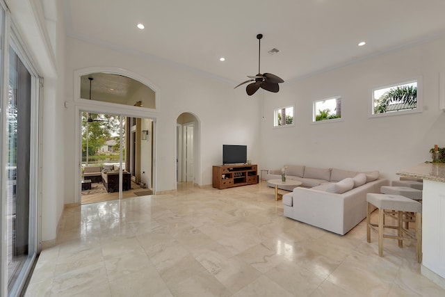 5036 NW 24th Cir, Boca Raton, FL 33431 - living area with arched walkways, crown molding, a ceiling fan, recessed lighting, and light marble finish floors