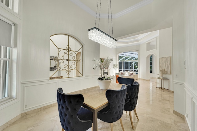 5036 NW 24th Cir, Boca Raton, FL 33431 - dining space with ornamental molding, a towering ceiling, a decorative wall, light marble finish flooring, and arched walkways
