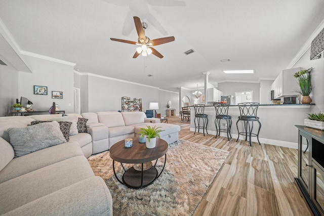 462 SW Sundance Trl, Port Saint Lucie, FL 34953 - living room with lofted ceiling, ceiling fan, light wood-style floors, crown molding, and baseboards