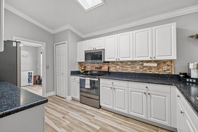462 SW Sundance Trl, Port Saint Lucie, FL 34953 - kitchen with appliances with stainless steel finishes, white cabinetry, tasteful backsplash, dark countertops, and crown molding