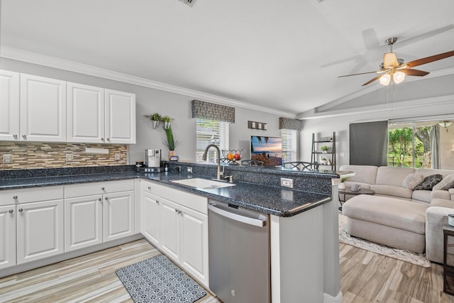 462 SW Sundance Trl, Port Saint Lucie, FL 34953 - kitchen with a sink, stainless steel dishwasher, open floor plan, vaulted ceiling, and light wood-style flooring