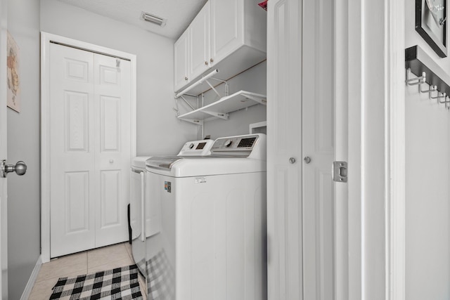 462 SW Sundance Trl, Port Saint Lucie, FL 34953 - laundry area with independent washer and dryer, cabinet space, light tile patterned floors, and baseboards