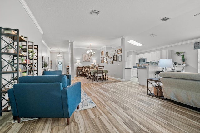 462 SW Sundance Trl, Port Saint Lucie, FL 34953 - living room featuring ornamental molding, light wood finished floors, baseboards, and a chandelier