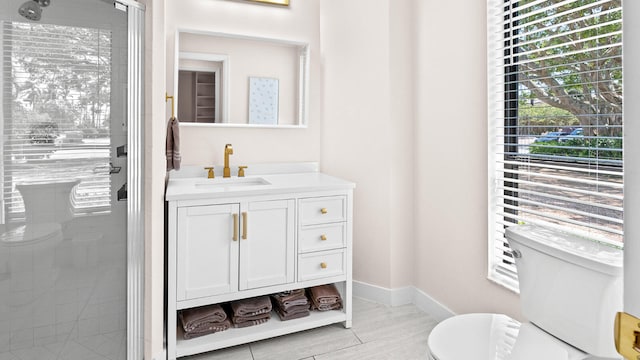 11354 Old Harbour Rd, North Palm Beach, FL 33408 - bathroom with toilet, a shower stall, vanity, and baseboards