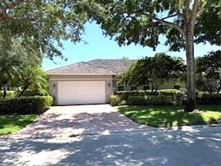 3924 NW 58th St, Boca Raton, FL 33496 - view of front of home featuring a garage and driveway