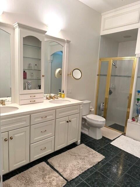 3924 NW 58th St, Boca Raton, FL 33496 - bathroom with a shower stall, double vanity, toilet, and tile patterned floors