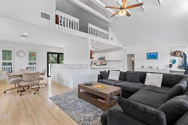 638 NE 8th Ave, Boynton Beach, FL 33435 - living area featuring light wood-style floors, a ceiling fan, high vaulted ceiling, recessed lighting, and baseboards