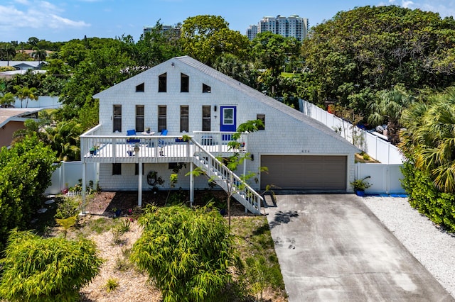 638 NE 8th Ave, Boynton Beach, FL 33435 - view of front of house featuring driveway, stairs, and view of scattered trees