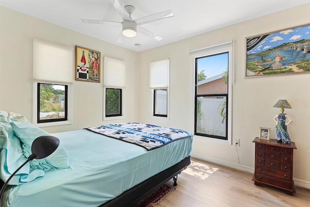 638 NE 8th Ave, Boynton Beach, FL 33435 - bedroom with light wood finished floors, baseboards, and a ceiling fan