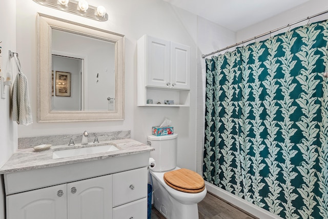 638 NE 8th Ave, Boynton Beach, FL 33435 - full bath with vanity, toilet, wood finished floors, and a shower with shower curtain